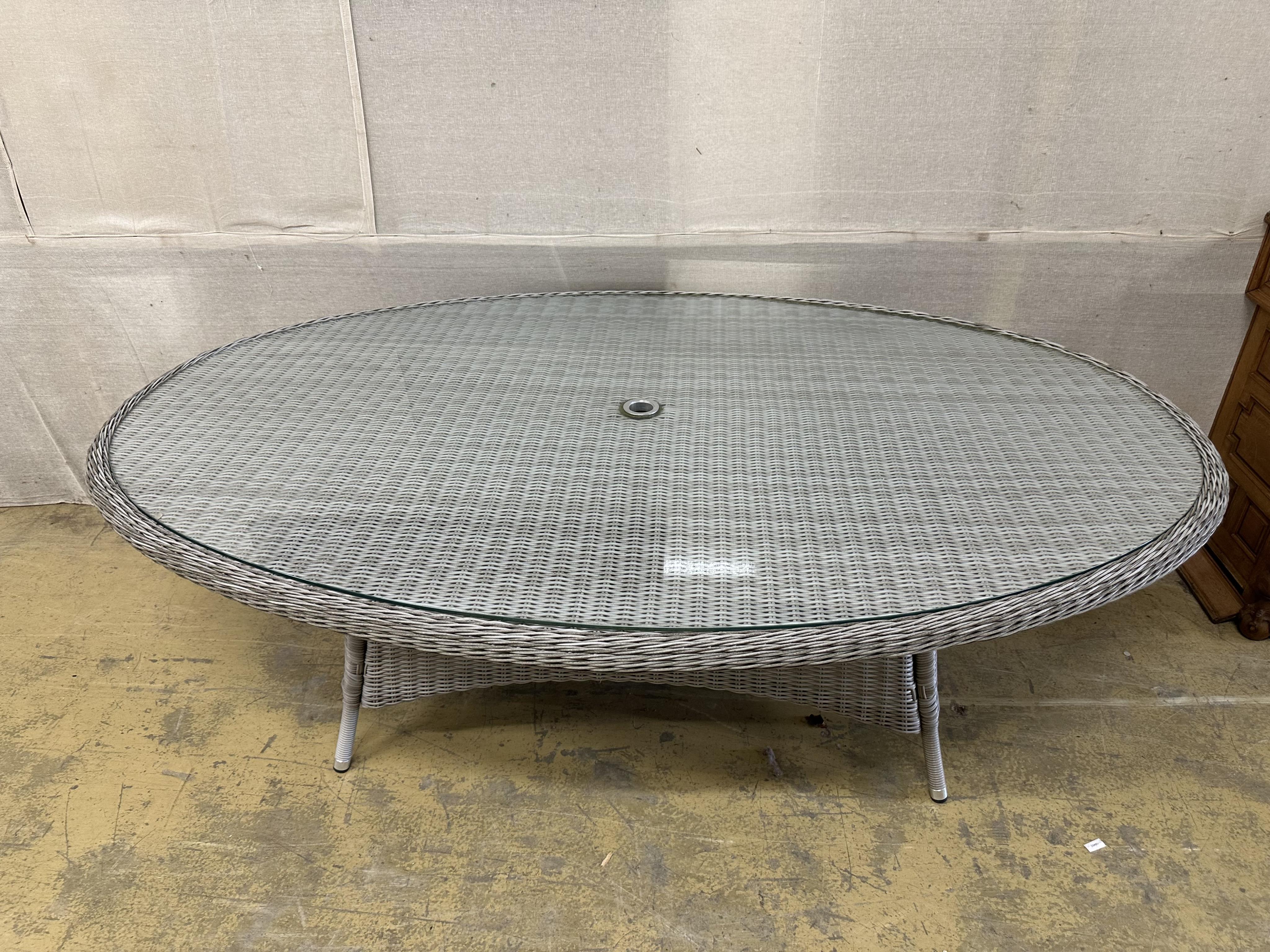 A Bramblecrest oval all weather rattan garden table, width 220cm, depth 145cm, height 73cm. Condition - good